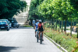 Person biking on a sunny path surrounded by nature – a simple hobby to start for better wellness