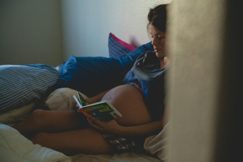 Pregnant woman practicing mindfulness to manage anxiety in a calm, cozy room.